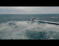 Drone shot shows icy water from lake