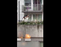 Man and Woman tiktok at building balcony