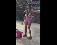 Lady wearing pink shorts dances alone 