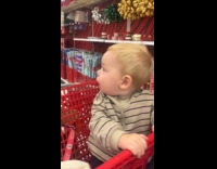 Toddler amused to see Christmas trees with lights