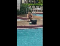 Woman bikini take picture of black bag blue towel