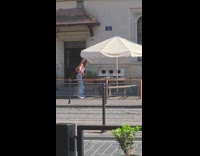 Woman pink crop top dances outside restaurant