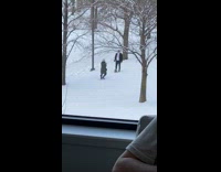 Guy sit on snow with small dog 