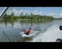 Pink wetsuit girl gets pulled by boat