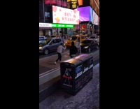 Nude models painted in white paint pose on bikes in the middle of busy NYC street
