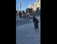 Woman on street pole poses for picture