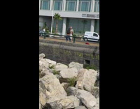 Woman brown crop top aggressive dance at the sidewalk