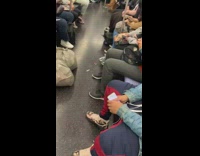 Guy braids mannequin hair on subway train