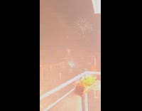 Filmer on balcony countdown show new year fireworks
