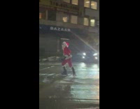 Santa rides rollerblades down street at night 