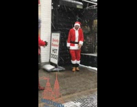 Guy Santa Claus suit gets down on one knee and takes a shot from bottle