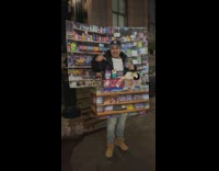Man with lots of trick or treats outside street in NY at night 