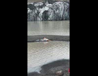 Woman in white dress lie down beside the glacier shore