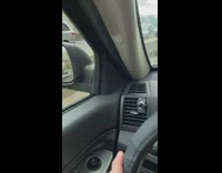 Man wearing helmet rides bicycle down highway 