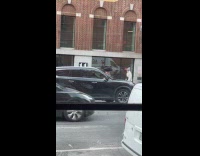 Man balances his bag on his head 