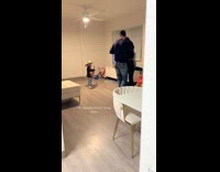 Little boy with guitar while parents dance