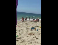 Pink bikini girl sits friend leans back 