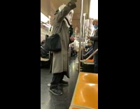 Person wears white hood vented mask subway