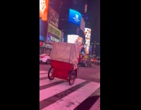 Santa drive tricycle with passengers on street