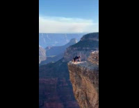 Guy push ups on canyon cliff edge