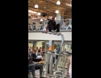 Man crossing on top of rear delt machines