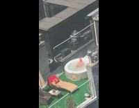 Guy sits in white jacuzzi rooftop balcony 