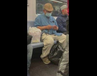 Guy trims nails on train 