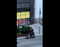 Man on bike singing its my life on karaoke 