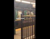 Guy in white mask stands alone behind yellow caution tape