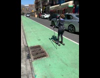Lady skis down street with ski poles 