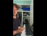 Guy playing piano puts on sunglasses 