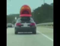 Red raft tied to black car raps 