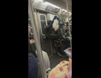 Man doing wheelie on bike while riding subway
