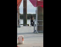 Girl dances alone brown shirt white bucket 