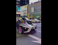 Grinch wearing santa suit drives white ATV