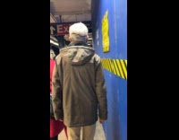 Old man walks with snoopy hair design