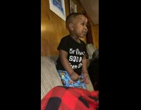 Kid on sofa throwing a tantrum and screaming cuss words 
