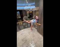 Drunk woman dancing inside cruise elevator