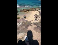 Two girls pose black sports bra beach 