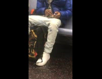 blue jacket man clips nails on train