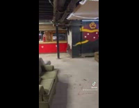 Guys shovel sand into basement for party