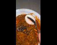 Womans stomach grumbles while filming noodles