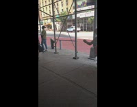 Guy sits orange shopping cart in line 