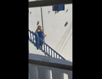 Blue dress girl walks down stairs guy 