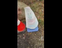 Mystery person draws and paints on street cones