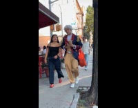 Man in colonial-era costume on the sidewalk