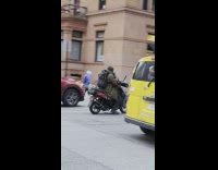 Motorcycle Rider Pulls Fellow Riders Motorcycle Across Street