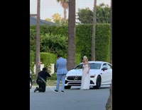 Woman wedding dress white car middle of street