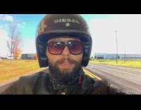 Guy pretends to ride motorcycle television screen 
