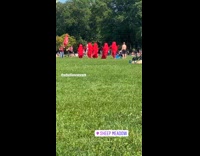 Five people wear long red religious garments 